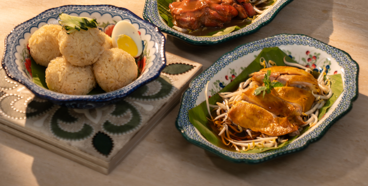 Hainanese chicken rice balls with poached chicken on banana leaf