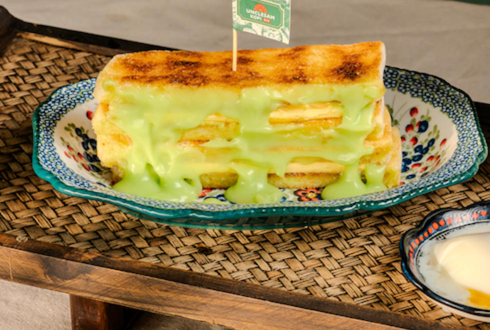 Charcoal toast with pandan custard on a floral plate